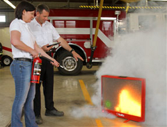 Two People Using a Fire Extinguisher
